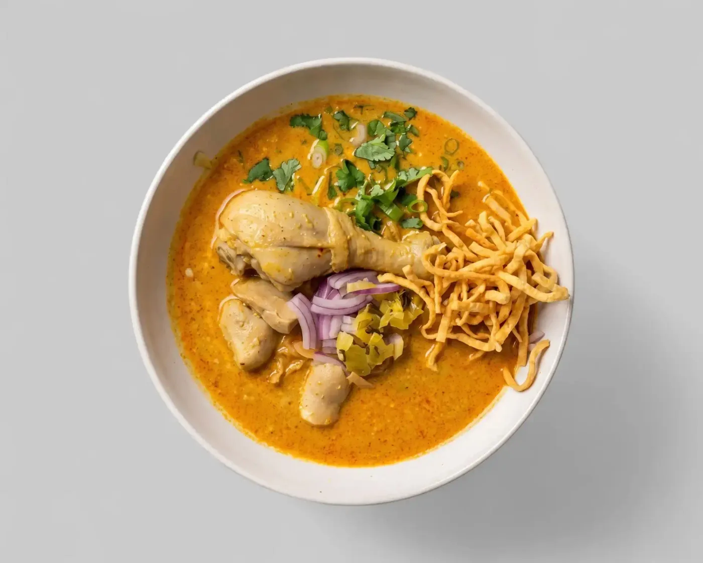 Sweet Rice Khao Soi with braised chicken, crispy noodles and shallots