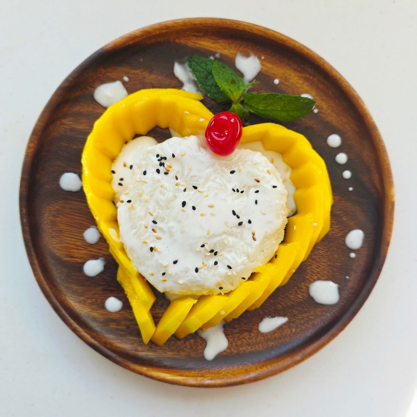 Sweet Rice Mango Sticky Rice with sliced mango, coconut cream and sesame seeds